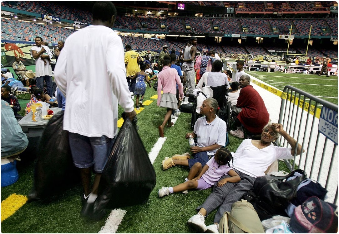 Figure 6. New Orleans residents sit in the Superdome, which is being used as an emergency shelter, before the arrival of Hurricane Katrina, Aug. 28, 2005, in New Orleans. Mario Tama/Getty Images